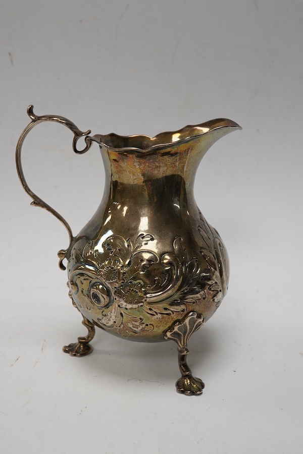 A George III silver cream jug, with later embossed decoration, London, 1766, 12.7cm, 5.7oz. Condition - poor